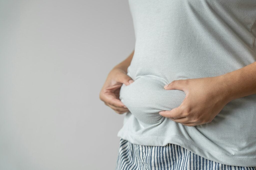 Overweight woman body concept of unhealthy lifestyle gain more fat and high risk to disease